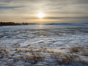 The sun about to set over a frozen slough east of Rockyford, Ab., on Tuesday, November 29, 2022.