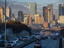 Cars move along Macleod Trail with the Calgary skyline in the background on Monday, December 12, 2022.