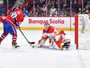 Calgary Flames goaltender Jacob Markstrom makes a blocker save on Montreal Canadiens forward Joel Armia at Bell Centre in Montreal on Monday, Dec. 12, 2022.