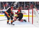 CALGARY, CANADA - DECEMBER 14: Sheldon Dries #15 of the Vancouver Canucks scores against Jacob Markstrom #25 of the Calgary Flames during the second period of an NHL game at Scotiabank Saddledome on December 14, 2022 in Calgary, Alberta, Canada.