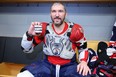 Alex Ovechkin of the Washington Capitals poses with the pucks from his 798th, 799th and 800th career goal after the game at United Center on December 13, 2022 in Chicago, Illinois.