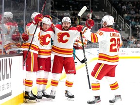 Calgary Flames forward Tyler Toffoli (second from left) celebrates with teammates after scoring a goal against the San Jose Sharks at SAP Center in San Jose, Calif., on Sunday, Dec. 18, 2022.