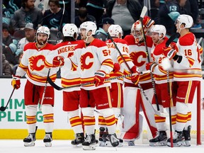 SEATTLE, WASHINGTON - DECEMBER 28: The Calgary Flames celebrate their 3-2 win against the Seattle Kraken at Climate Pledge Arena on December 28, 2022 in Seattle, Washington.