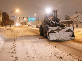 An excavator drives through Buffalo, N.Y., Tuesday, Dec. 27, 2022.