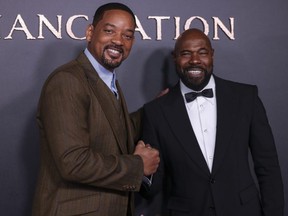 Will Smith, left, and director Antoine Fuqua pose for photographers upon arrival for the premiere of the film 'Emancipation' in London, Friday, Dec. 2, 2022.