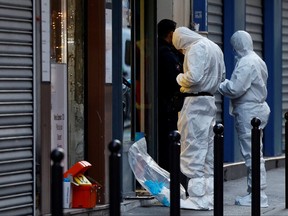 French scientific police work on Rue d'Enghien after gunshots were fired killing and injuring several people in a central district of Paris, Dec. 23, 2022.