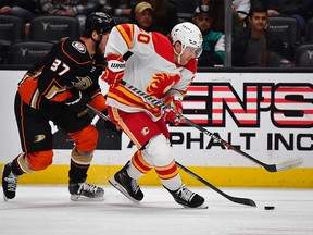 Calgary Flames forward Blake Coleman (20) moves the puck ahead of Anaheim Ducks forward Mason McTavish (37) during the first period at Honda Center on Dec. 23, 2022 in Anaheim, California, USA.