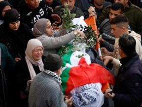 Mourners carry the body of Palestinian teen Jana Zakarna during her funeral n Jenin, in the Israeli-occupied West Bank, December 12, 2022.