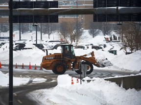 A worker uses heavy machinery to remove snow at Buffalo Niagara International Airport, following a deadly Christmas blizzard, in Cheektowaga, New York, December 27, 2022.