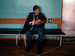 A local resident injured after a shelling sits in a hospital in Kherson on December 21, 2022, amid the Russian invasion of Ukraine.