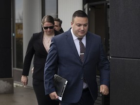 Cpl. Randy Stegner, front, and Const. Jessica Brown leave court after another day of their jury trial on charges of manslaughter with a firearm, aggravated assault and discharging a firearm with intent to cause bodily harm, in Edmonton on Friday, Nov. 25, 2022.