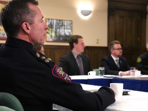 Police Chief Mark Neufeld listens in at a meeting of a new task force to help tackle homelessness and public safety in Calgary on Friday.