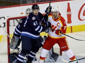 Calgary Wranglers captain Brett Sutter, pictured battling the Manitoba Moose, is set to become only the eighth player to log 1,000 appearances in the American Hockey League.
