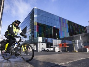 A police officer rides his bike around the fenced off perimeter of the Convention Centre ahead of the COP15 UN conference on biodiversity in Montreal, Thursday, Dec. 1, 2022.