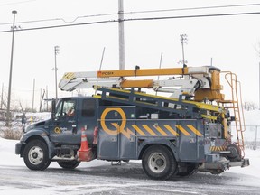 A Hydro Quebec truck is shown in an area without power in Montreal, Saturday, Dec. 24, 2022, following a winter storm in the region.&ampnbsp;Utility crews in Ontario, Quebec and New Brunswick are still working to restore electricity to thousands of customers who have been in the dark for days after last week's fierce winter storms knocked out their power.