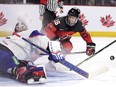 Canada's Connor Bedard drives to the net as Slovakia goaltender Patrik Andrisik makes a save during second period IIHF World Junior Hockey Championship pre-tournament hockey action in Moncton, N.B., on Wednesday, Dec. 21, 2022.