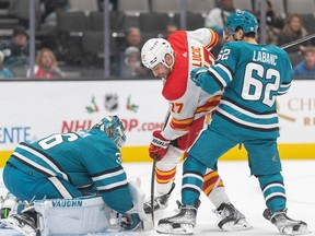 Calgary Flames forward Milan Lucic battles in front of the San Jose Sharks goal crease at SAP Center on Sunday.