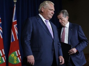Ontario Premier Doug Ford and Toronto Mayor John Tory, shuffle during a joint press conference inside Queen's Park in Toronto, June 27, 2022.