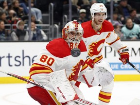 Calgary Flames goaltender Dan Vladar keeps his eye on the puck during a game against the Seattle Kraken on Wednesday.