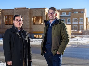 Gerrard Oishi, Habitat for Humanity Southern Alberta president and CEO, left, and Avalon Master Builder CEO Ryan Scott pose for a photo on Tuesday, January 17, 2023.