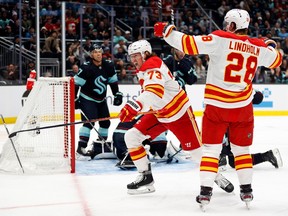 Calgary Flames forward Tyler Toffoli celebrates a goal, along with linemate Elias Lindholm, against the Seattle Kraken at Climate Pledge Arena in Seattle on Dec. 28, 2022.