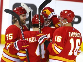 Flames Noah Hanifin, Rasmus Andersson and Nikita Zadorov congratulate goals Jacob Markstrom on the victory during NHL action between the New York Islanders and the Calgary Flames in Calgary on Friday, January 6, 2023. Jim Wells/Postmedia