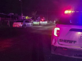 In this image released by Tulare County Sheriff's Office, detectives investigate a shooting in Goshen near Visalia, Calif., early morning Monday, Jan. 16, 2023.