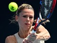 Italy's Camila Giorgi hits a return against Russia's Anastasia Pavlyuchenkova during their women's singles match on day two of the Australian Open tennis tournament in Melbourne on January 17, 2023.