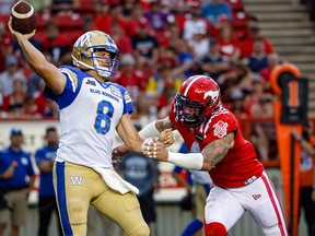 Winnipeg Blue Bombers quarterback Zach Collaros throws under pressure from Cameron Judge of the Calgary Stampeders during CFL football in Calgary on Saturday, July 30, 2022.