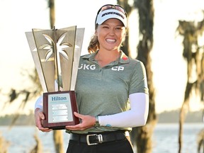 Canada's Brooke Henderson poses with the trophy after winning the Hilton Grand Vacations Tournament of Champions at Lake Nona Golf & Country Club on Sunday in Orlando, Fla.
