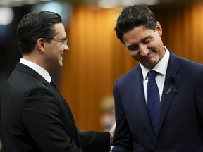 Prime Minister Justin Trudeau and Conservative Leader Pierre Poilievre greet each other as they gather in the House of Commons on Parliament Hill to pay tribute to Queen Elizabeth in Ottawa on Thursday, Sept. 15, 2022.