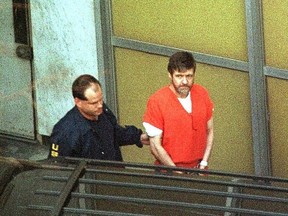 Escorted by armed US marshals, Unabomber suspect Theodore Kaczynski leaves the Federal Courthouse, Sacramento, California, January 22, 1998. (Photo credit should read BOB GALBRAITH/AFP via Getty Images)