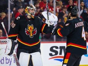 Calgary Flames goaltender Dan Vladar (80) and defenceman Rasmus Andersson (4) celebrate their win over the Tampa Bay Lightning at the Scotiabank Saddledome in Calgary on Jan. 21, 2023.