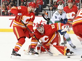 Calgary Flames goalie Jacob Markstrom (25) stops a shot against the Vancouver Canucks during the second period at the Scotiabank Saddledome in Calgary on Dec. 31, 2022.