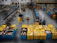 Workers select and pack items during Cyber Monday at the Amazon fulfilment centre in Robbinsville Township in New Jersey, Nov. 28, 2022.