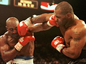 Evander Holyfield (L) and Mike Tyson (R) trade punches 28 June in their WBA heavyweight Cchampionship fight at the MGM Grand Garden Arena in Las Vegas, NV. Holyfield won by disqualification in the the third round after Tyson bit his ear. (JEFF HAYNES/AFP via Getty Images)