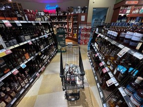 A person's purchases are seen in a shopping cart at a government-run BC Liquor Store in Vancouver, on Friday, August 19, 2022.