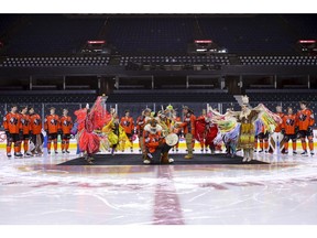 Calgary Hitmen players, Farley the Fox, dancers and Sorrel Rider drummers take part in an Every Child Matters press conference at Scotiabank Saddledome in Calgary on Wednesday, Jan. 11, 2023. The players wore uniforms designed for the Every Child Matters game on Feb. 4.