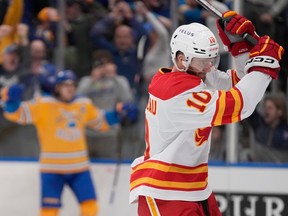 Calgary Flames forward Jonathan Huberdeau (10) reacts after St. Louis Blues forward Robert Thomas, left, scored during overtime at Enterprise Center in St. Louis on Tuesday, Jan. 10, 2023. The Blues won 4-3.