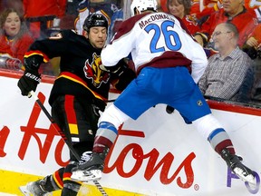 Calgary Flames forward Milan Lucic battles Colorado Avalanche defenceman Jacob MacDonald at the Scotiabank Saddledome in Calgary on Wednesday, Jan. 18, 2023.