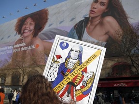 Women and activists march to mark International Women's Day, in Paris, Monday, March 8, 2021.