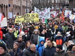 Protesters march during a demonstration as part of a nationwide day of strikes and rallies for the second time in a month, to protest a planned reform to boost the age of retirement from 62 to 64, in Strasbourg, eastern France on Jan. 31, 2023.