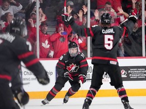 Canada's Connor Bedard, centre, reacts after scoring the game-winning goal in overtime of IIHF World Junior Hockey Championship quarterfinal action against Slovakia in Halifax, Monday, Jan. 2, 2023.