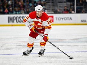 Mikael Backlund advances the puck against the Seattle Kraken during the third period at Climate Pledge Arena. Calgary defeated Seattle 5-2.