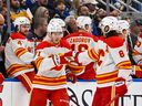 Calgary Flames forward Walker Duehr (71) is congratulated by defenceman Chris Tanev after scoring his first career NHL goal against the St. Louis Blues at Enterprise Center in St. Louis on Thursday, Jan. 12, 2023. 