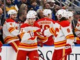 Calgary Flames forward Walker Duehr (71) is congratulated by defenceman Chris Tanev after scoring his first career NHL goal against the St. Louis Blues at Enterprise Center in St. Louis on Thursday, Jan. 12, 2023.