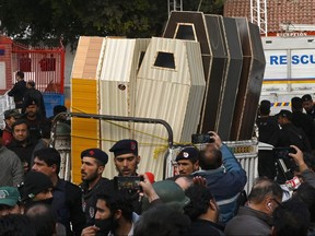 A vehicle transports caskets for bodies of the victims who died in a mosque blast inside the police headquarters in Peshawar on Jan. 30, 2023.