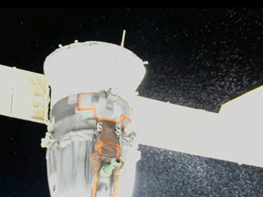 This file video grab from a NASA feed obtained Dec. 15, 2022 shows liquid spraying from the aft end of the Soyuz MS-22 spacecraft.