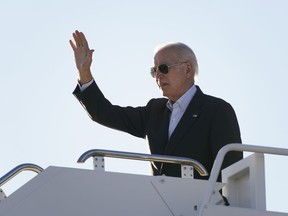President Joe Biden waves before boarding Air Force One at El Paso International Airport in El Paso, Texas, Sunday, Jan. 8, 2023.