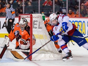 Calgary Hitmen goaltender Brayden Peters makes a save against Edmonton Oil Kings forward Marshall Finnie during the Every Child Matters Game at Scotiabank Saddledome in Calgary on Saturday, Feb. 4, 2023.